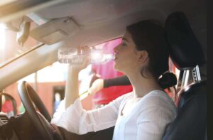 Driver drinking water during a summer journey